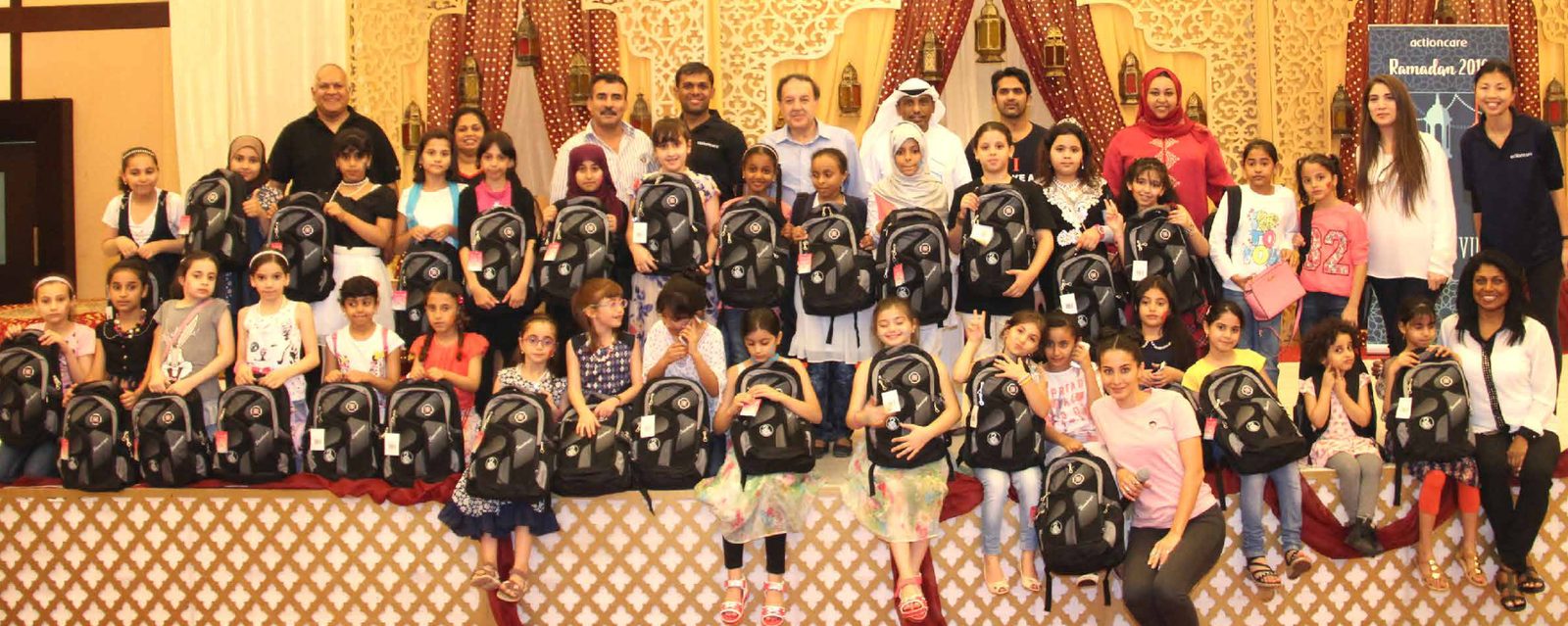 Gift of Giving Ramadan event — children with backpacks and volunteers