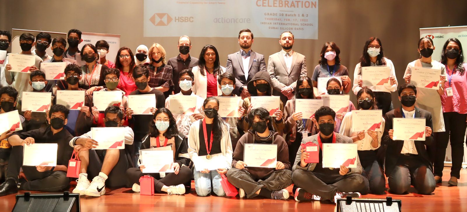MoneyMasters students with certificates at a financial literacy celebration